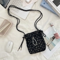 Detail of floral drawstring crossbody bag with textured fabric and braided rope strap - Black Floral
