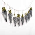 Hanging Easter carrot banner featuring black and white plaid fabric on a rustic twine string - Black and White Plaid Carrot Garland
