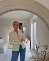 Detail view of cream tailored blazer with single gold metal buckle and deep V-neckline - S / White