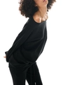 Side view of black off-shoulder sweatshirt and flared pants set showing drape and fit - Black Hoodie