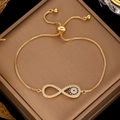Gold infinity bracelet with cubic zirconia and evil eye charm on jewelry box - Gold Infinity with Evil Eye Charm