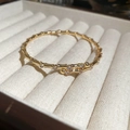 Detailed macro view of 18K gold bamboo-joint bangle featuring micro-set zircon accents - Bamboo Bangle / Gold