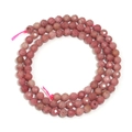 Faceted pink natural stone beads for DIY jewelry making on white background - Rhodochrosite