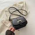 Minimalist black square crossbody bag featuring a golden H-shaped metal buckle and strap - Black