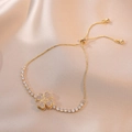 Elegant gold adjustable clover bracelet with sparkling zircon stones on champagne satin - Rotating Heart Bracelet (TS0071) / Gold