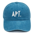 Detailed view of the white APT. embroidery on a blue washed cotton baseball cap texture - Lake Blue