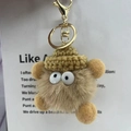 Brown fuzzy plush keychain featuring a knitted hat and big eyes on a decorative card - Khaki