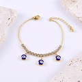 Elegante bracciale occhio greco dorato con strass bianchi e ciondoli blu lucidi - Occhio