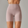 Detail of high waisted yoga shorts showing tummy control and seamless fit on model - Dusty Rose