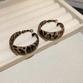 Macro detail of retro leopard print hoop earrings on a beige wavy jewelry display - 44# Coffee & Black