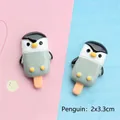 Detailed macro view of 2x3.3cm resin penguin popsicle charms for DIY phone case making - Penguin Popsicle
