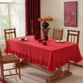 Detail of red cotton-linen tablecloth featuring decorative ruffled edges on wood table - Big Red Lotus