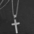 Collier avec pendentif croix en acier inoxydable poli argenté sur fond texturé sombre - Argenté