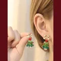 Handmade beaded Christmas tree earrings with gold bows and red beads on ear - 14k Gold Plated Bow-Triangle Clip / Clip-On Earrings
