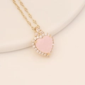 Close-up of gold heart necklace with pink gemstone and clear zirconia accents - Pink