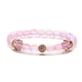 Close-up of pink frosted crystal beads and rose gold crown charm on a stretch bracelet - Moonstone