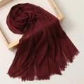 Detail view of burgundy cotton linen scarf with frayed edges on a wooden frame - 180*100cm / Jujube Red (TH39-33)