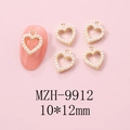 Detail of 10x12mm gold heart nail charm with pearl inlay on a pink mock nail design - Gold Heart Pave Artificial Pearl Charm (9912)