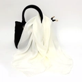 Close-up of a creamy white satin square scarf elegantly draped on a black leather handbag - One Size / Faux Silk Satin / Milky White
