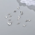 S925 sterling silver earring backs in platinum finish scattered on grey background - Silver