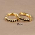Detail of 10mm golden hoop earrings with black zircon inlays on a textured surface - 10mm Gold Black Rhinestone (E1014-10mm)