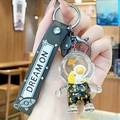 Astronaut liquid sand keychain with black strap and golden glitter stars - Black Gold Astronaut - Sitting Moon