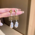 Detailed macro view of baroque pearl drop earring with golden hollow knot design - Baroque Pearl Hollow Style (HE10163) / Gold Earrings with Silver Pin
