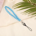 Detail of blue and white braided phone wrist strap with metal clasp on textured background - 10mm Width / Blue