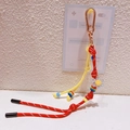 Lanière de téléphone tressée à la main avec cordon rouge-jaune et fleur smiley - 48.A08 Pendentif Fleur Rouge Jaune