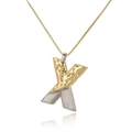 Macro shot of two-tone letter X pendant with hammered gold and smooth silver finish - Letter X