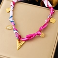 Pink silk fabric necklace with golden heart and geometric metal charms on beige pad - Pink Fabric Wrap Style (N3625)