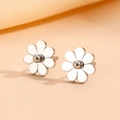 Silver daisy stud earrings in minimalist floral design on warm textile background - Steel Color Stud Earrings (B313)