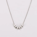 Detail of silver stainless steel necklace featuring seven small cube beads on a fine chain - Silver