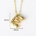Macro shot of gold letter E pendant with crystal inlay showing precise 21mm by 16mm measurements - Letter E(XED218)