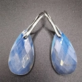 Macro shot of faceted blue teardrop gemstone earrings with silver-tone hooks - 13*25*6MM / Opalite