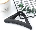 Elegant black triangular claw clip for hair styling on a decorative background - Matte Black