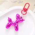 Pink metallic acrylic balloon dog keychain on a white tray with sleek silver chain - Rose Red