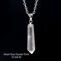 Detail view of a small 3.2x0.8 cm clear quartz hexagonal point pendant on a silver chain - Small White Crystal