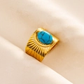 Close-up of a wide gold ring featuring radial sunburst texture and an oval turquoise stone - Gold-Deep Blue