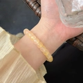 Elegant beaded bracelet featuring amber crystal beads on a female wrist accessory - Light Yellow Amber-like Beaded (MY37864)