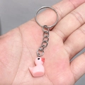 Pink resin duck keychain pendant with silver metal ring shown on hand - 25mm Ring / Pink