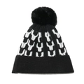 Dettaglio ravvicinato della trama a maglia e del pompon nero sul berretto invernale - M (56-58cm) / Nero