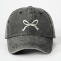 Detailed close-up of white bow embroidery on washed charcoal grey cotton baseball cap - One Size / Black