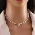White beaded necklace featuring a golden heart and shell letter U pendant on model - Letter U