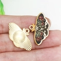 DIY colorful enamel and golden metal butterfly pendants shown on fingers for size guide - Black Red Rose Butterfly 18x29mm