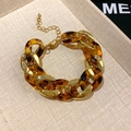 Detail of vintage gold chain bracelet with amber resin links on a textured beige tray - 35# Bracelet - Gold - Brown Leopard Thick Chain