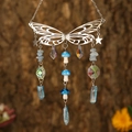 Silver butterfly suncatcher with blue mushroom beads and sparkling crystals on bark background - Silver Wings + Aquamarine Chips