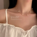Elegant gold freshwater pearl collar necklace on woman in white ruffled top - Real Gold Plated Multi-Pearl Chain Style