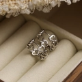 Polished silver hollow heart hoop earrings on beige velvet jewelry box background - Silver Hollow Linked Hearts Style (44270)