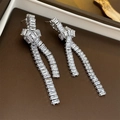 Detailed view of silver knot earrings with zircon fringes and dangling rectangular stones - Silver Zirconia Knotted Tassel Earrings